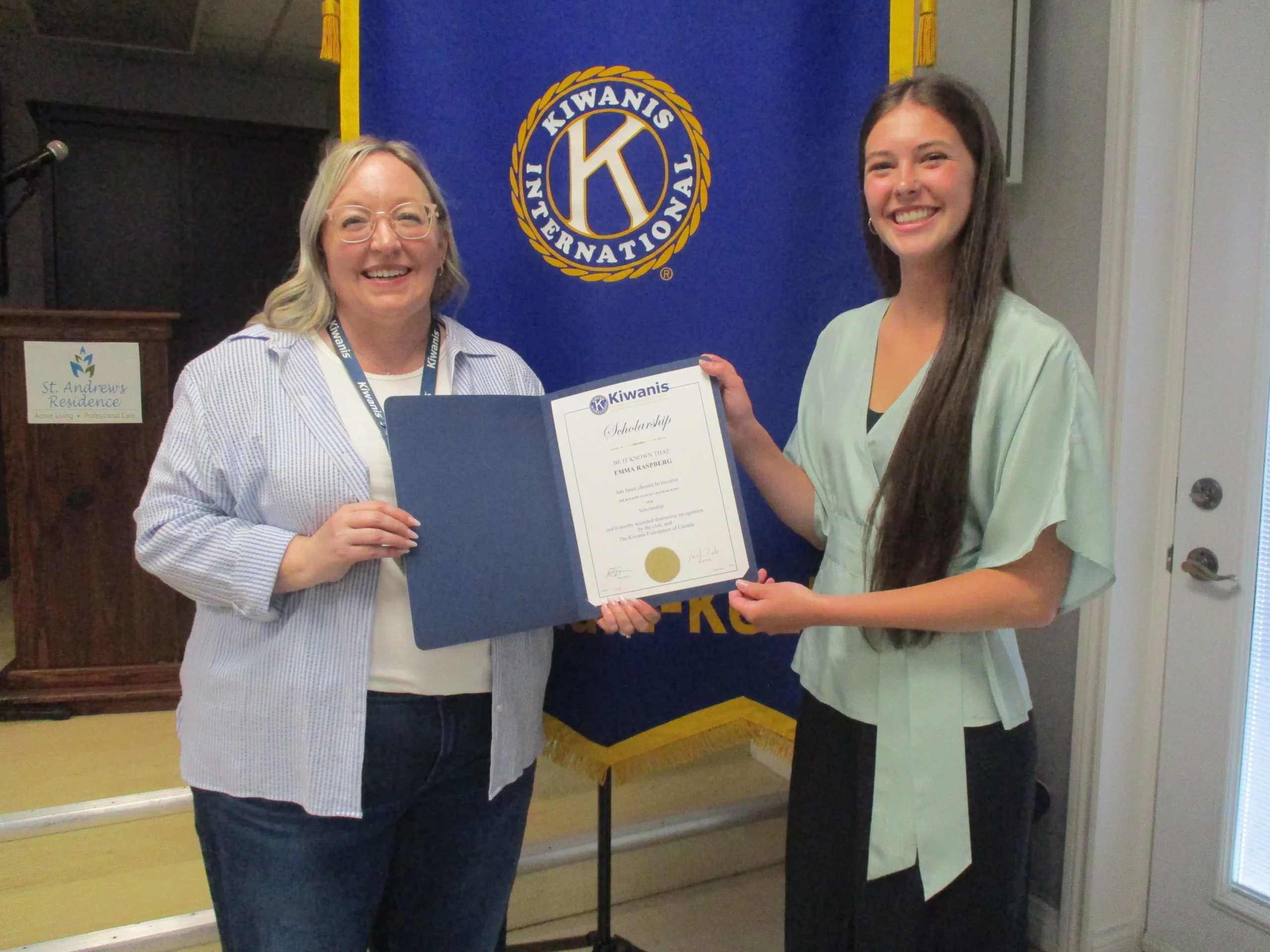On the left Kiwanis Scholarship Committee member, Bridget Blonde, presents a 00 Kiwanis Foundation of Canada Matching Scholarship to Emma Raspberg.